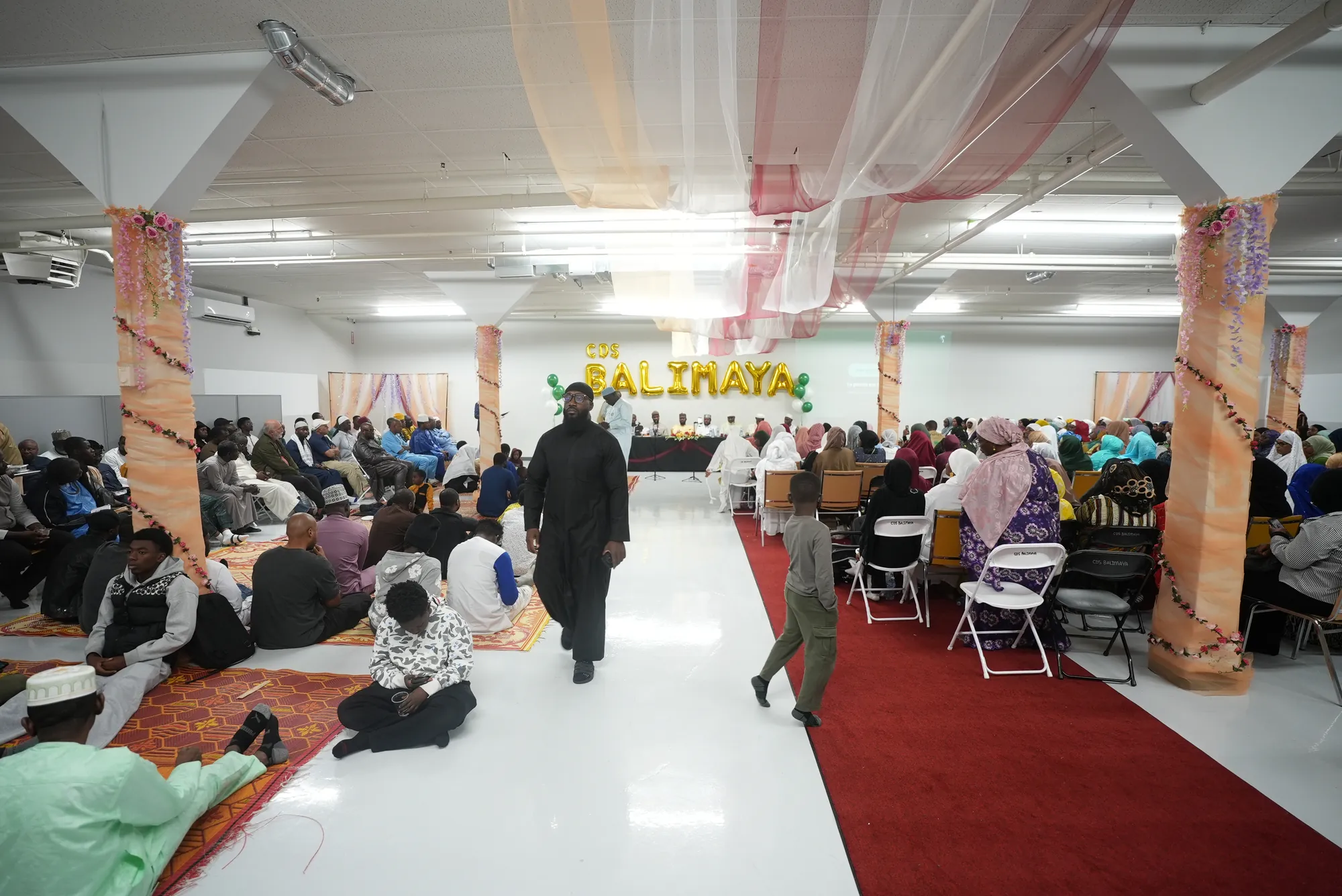 The hall full for a centre event, under the Balimaya banner.