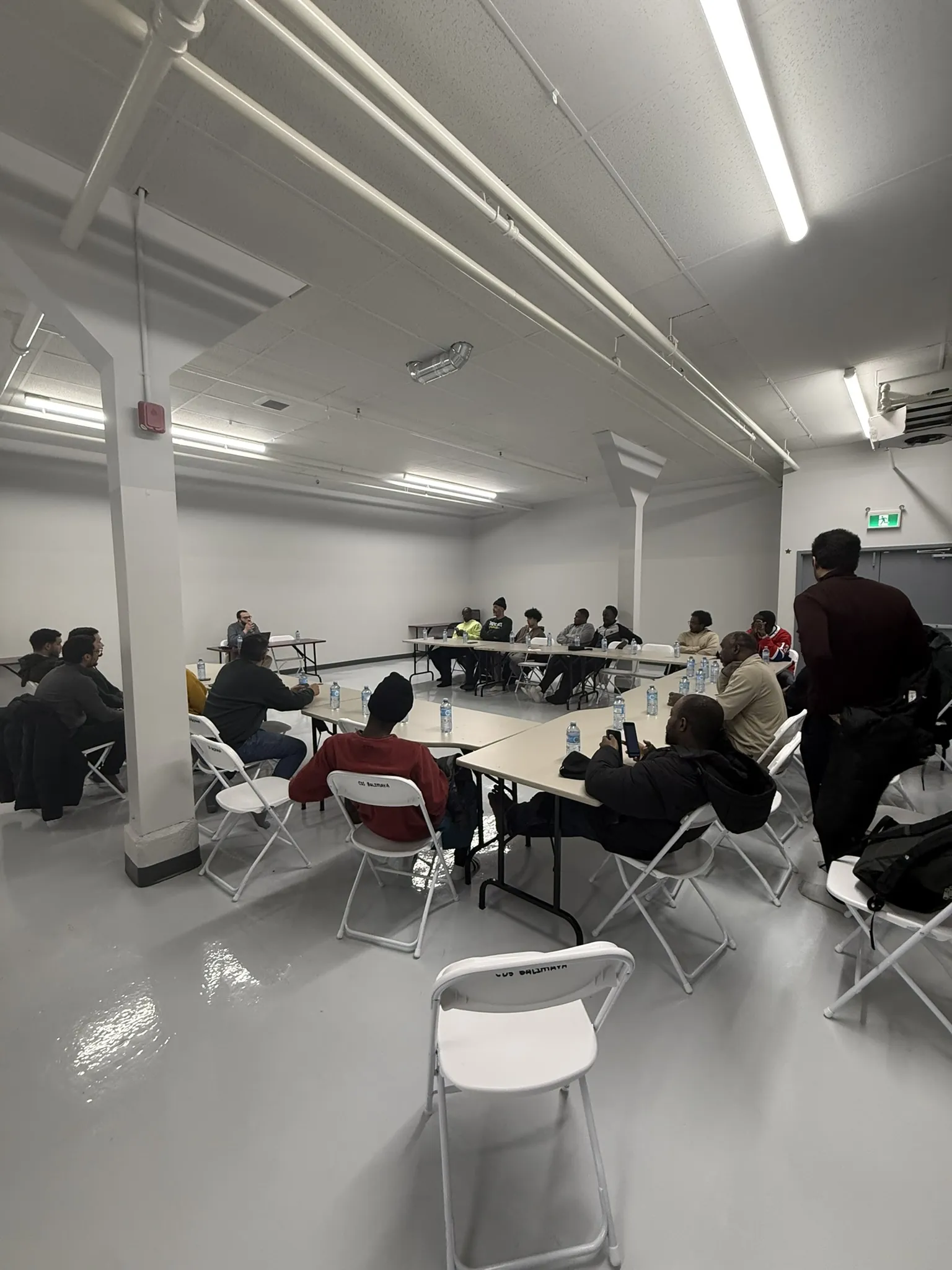 The empty hall, tables and chairs along the walls.