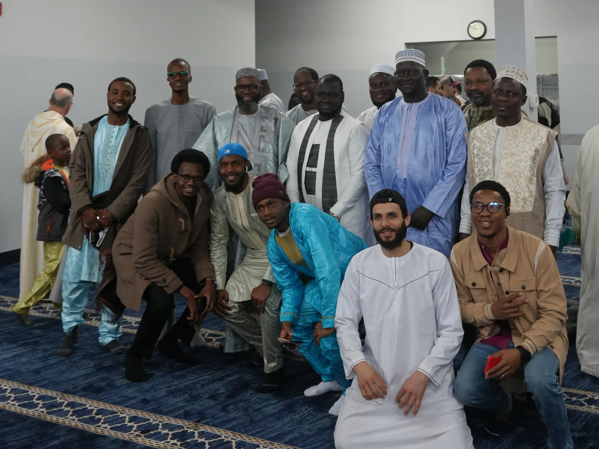 A large group photo in the prayer hall, young and old.